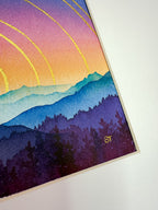 Colorful mountain landscape with a rainbow and silhouette of trees on a white background