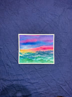 Colorful mountain landscape painting on a textured blue surface